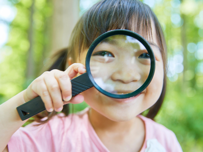 Girl with magnifying glass