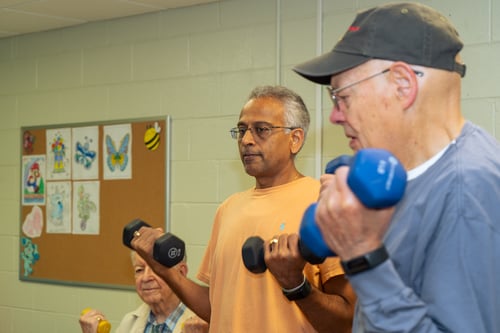 Participant lifting weights with the YMCA Veterans Wellness Program