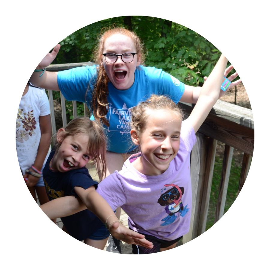 Young campers and counselor having fun at summer camp