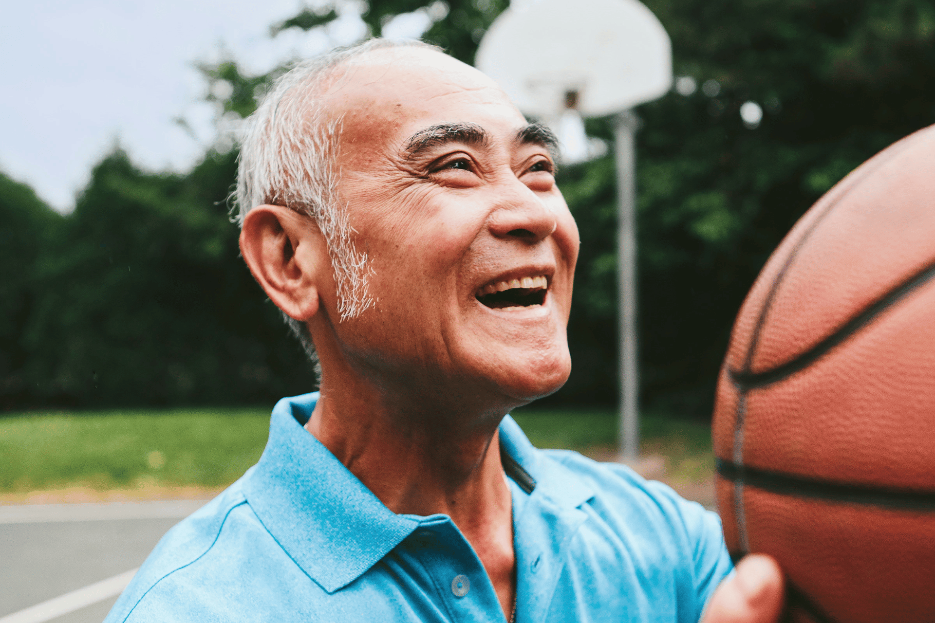 Older man shooting a basketball at the YMCA