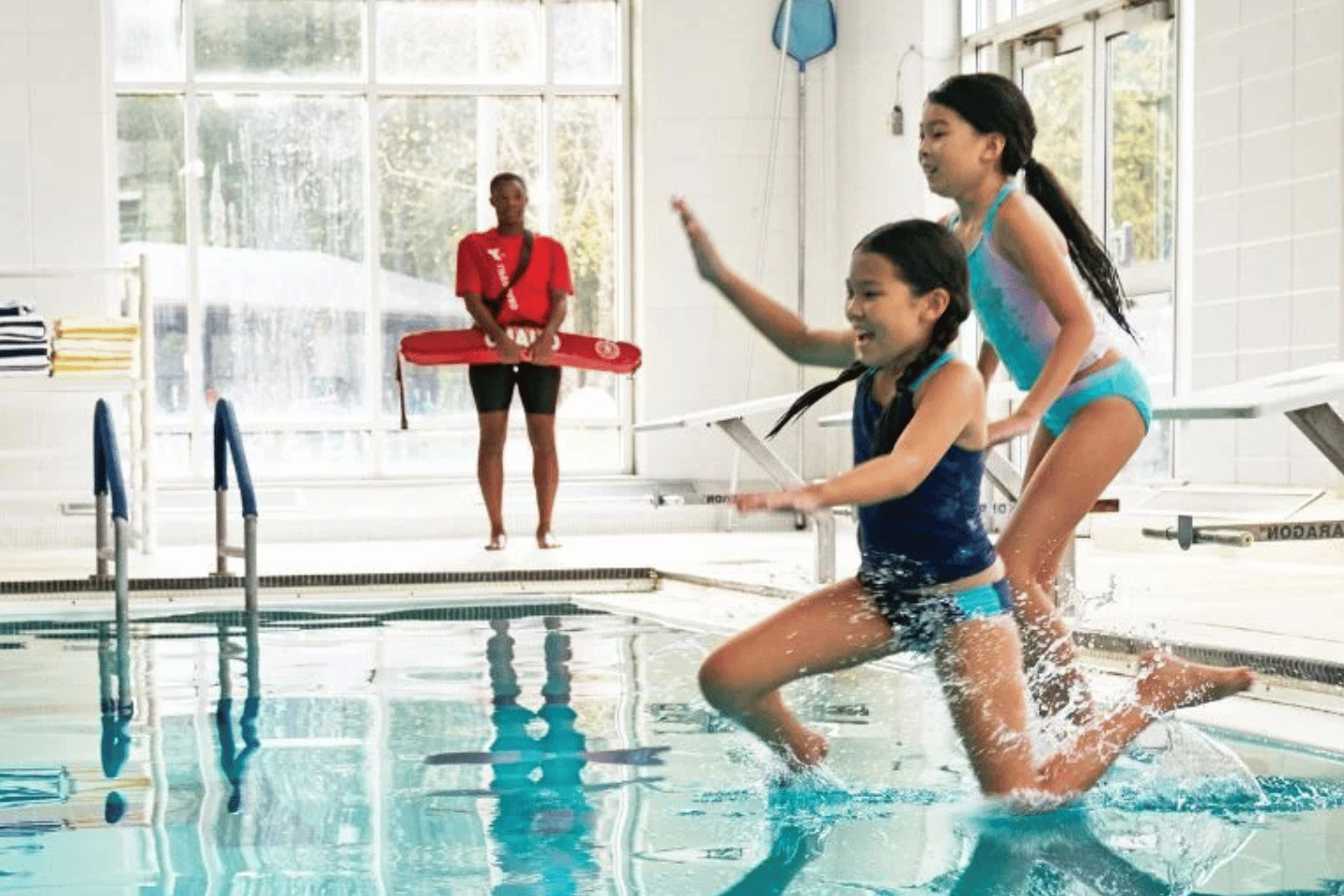 Kids jumping into a YMCA pool