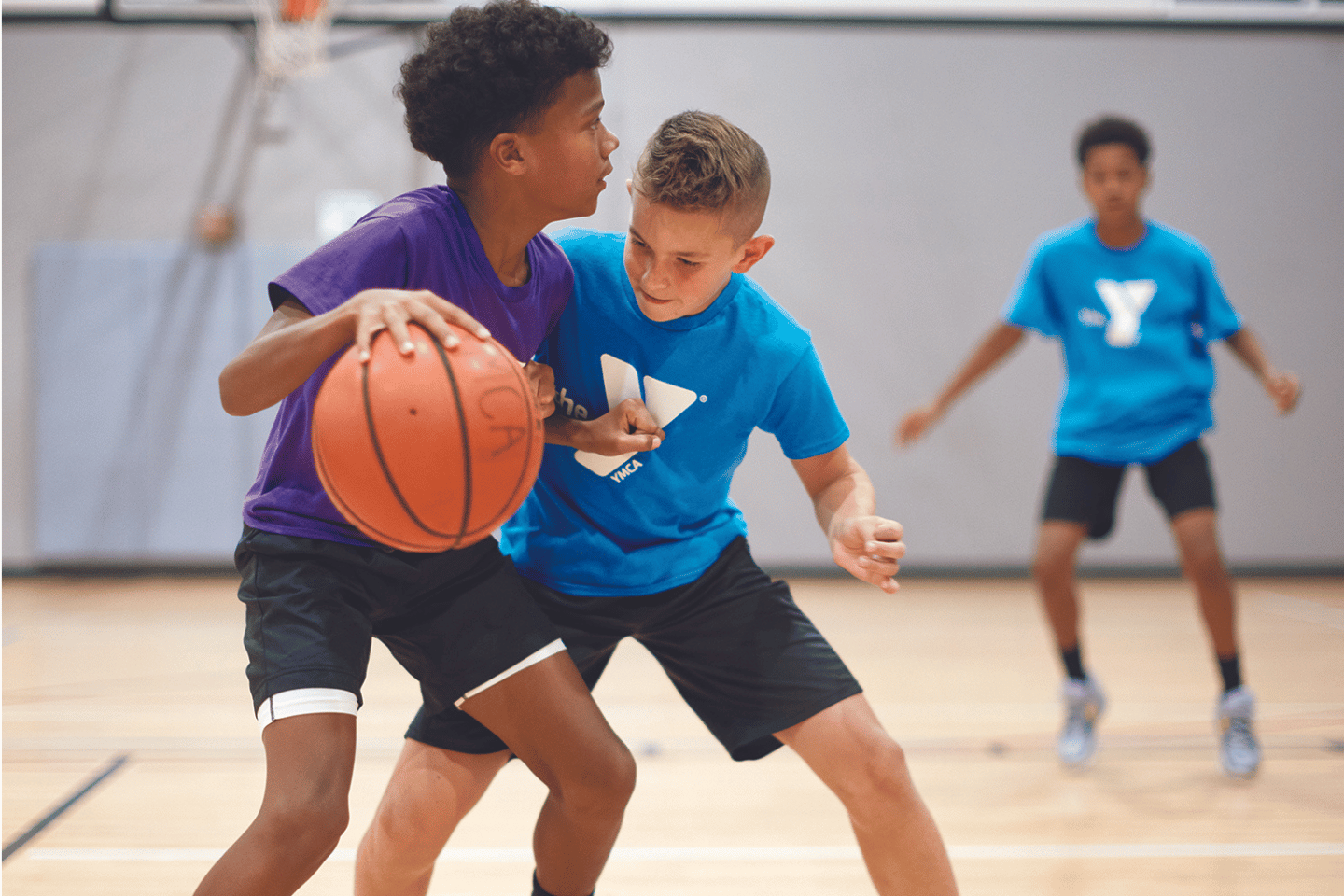 Kids playing youth basketball at the YMCA