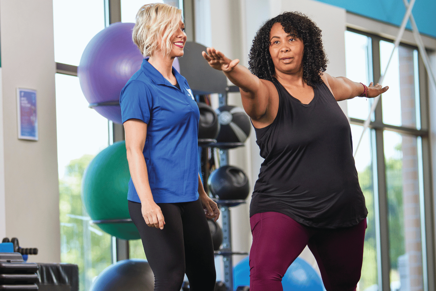 A personal trainer and YMCA member working out