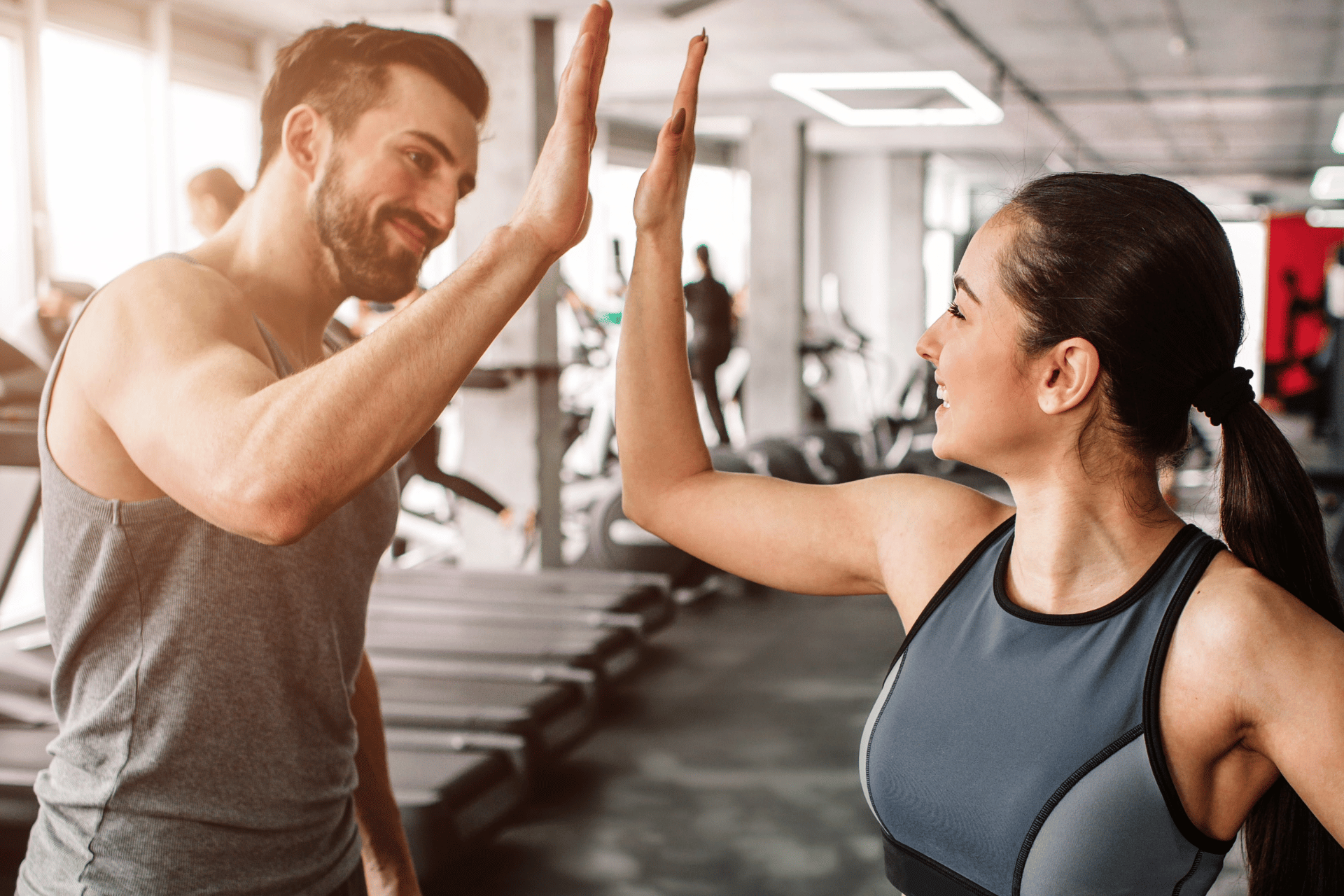 adult couple high-fiving at the Metro YMCA of the Oranges gym