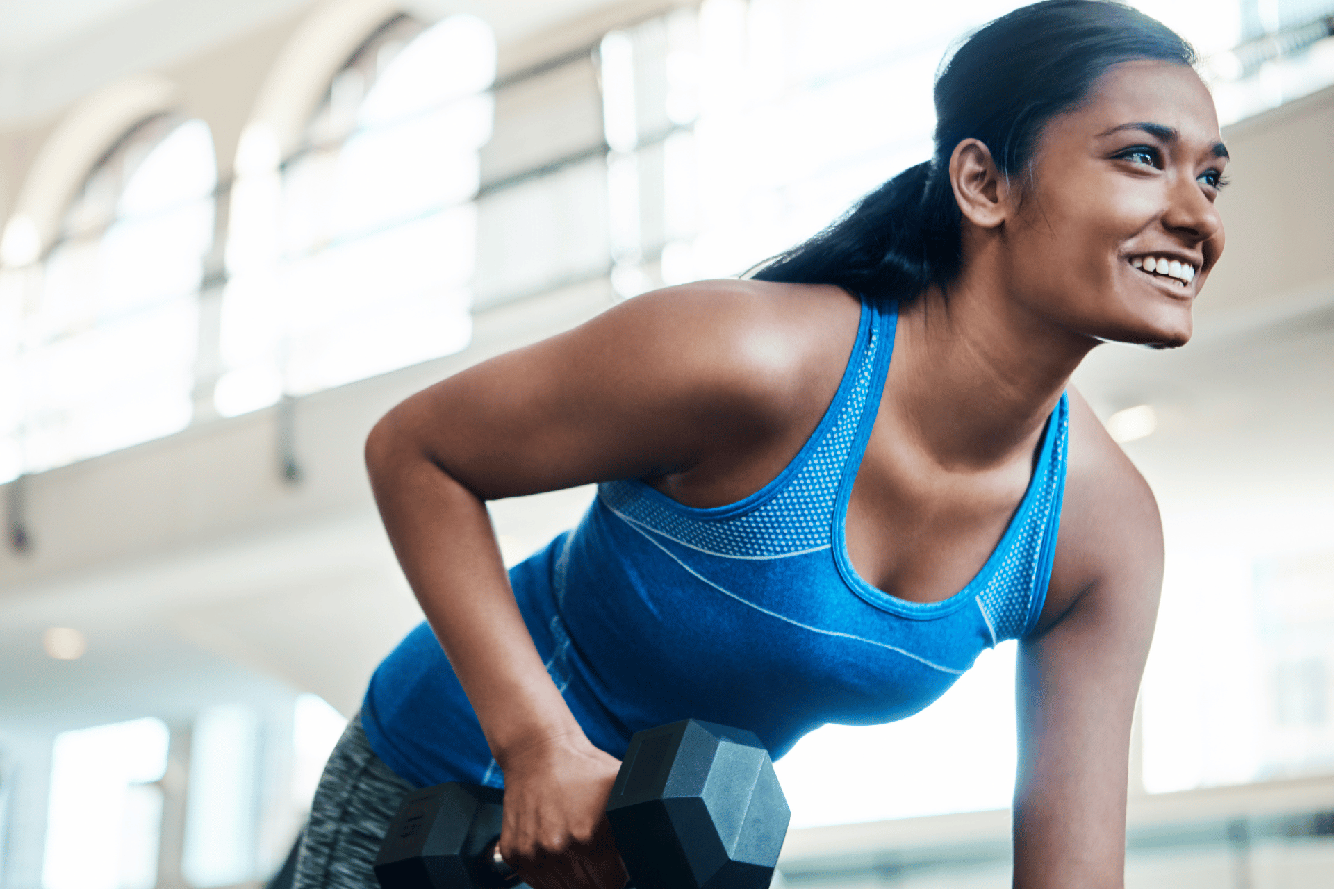 Young woman lifting weights at the Metro YMCA of the Oranges