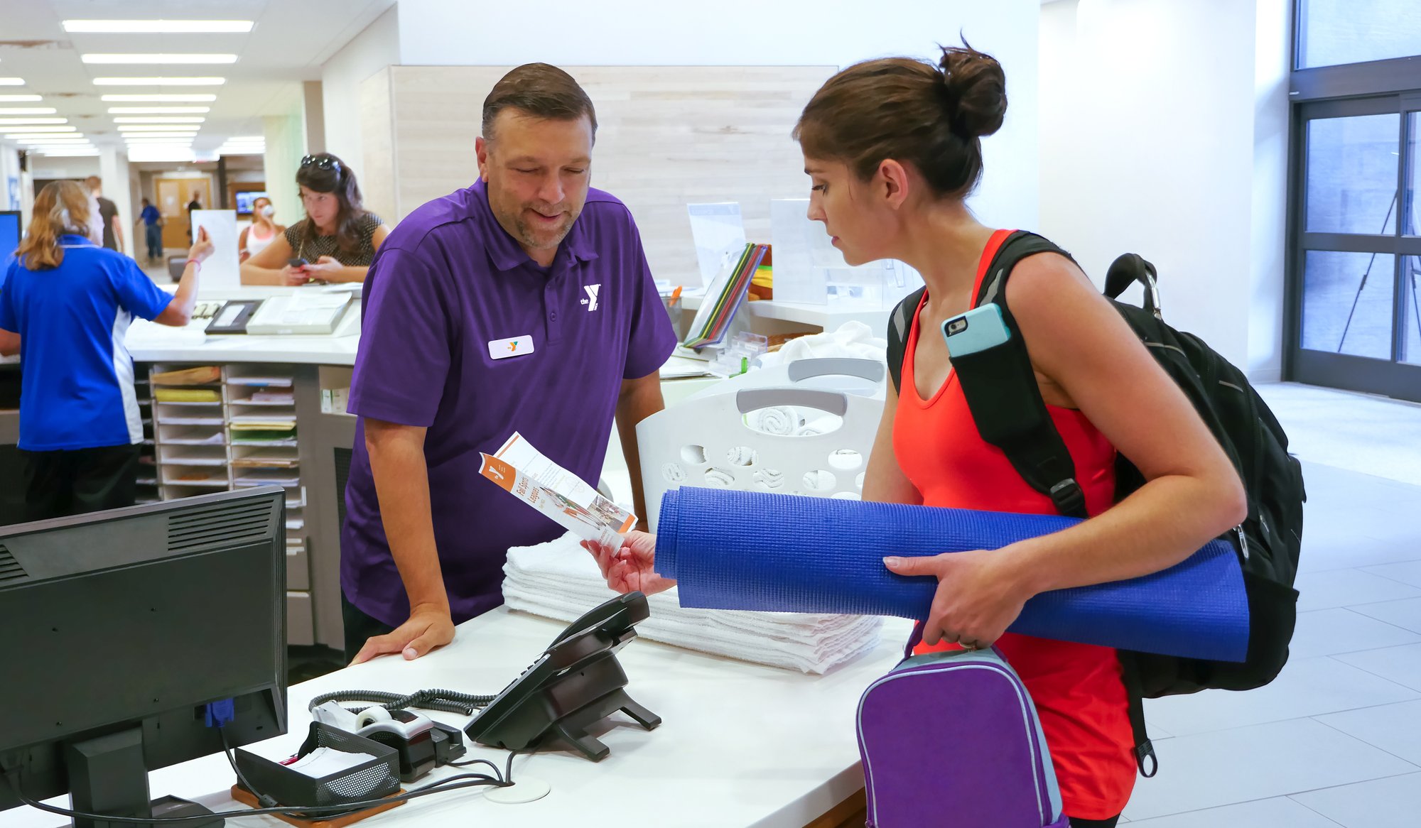 Woman checking in at the welcome desk at the YMCA