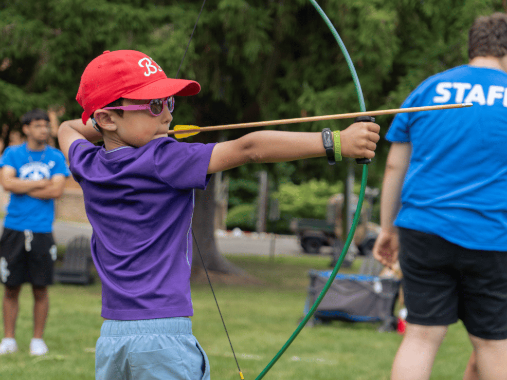 Kid learning archery at Pioneer Summer Day Camp at the West Essex YMCA