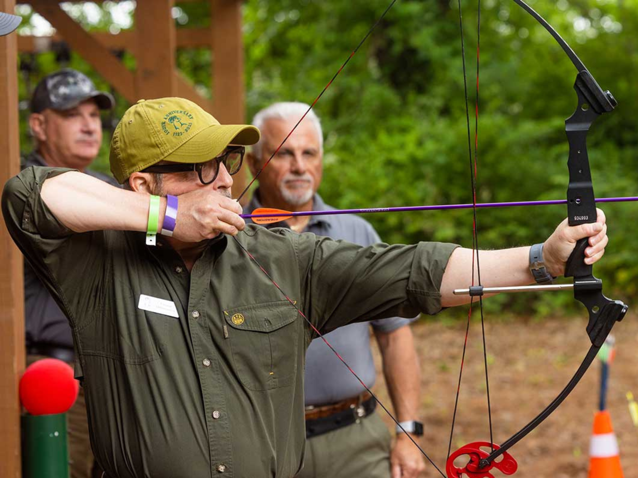 A man shooting a bow and arrow at the YMCA Sporting Clays event