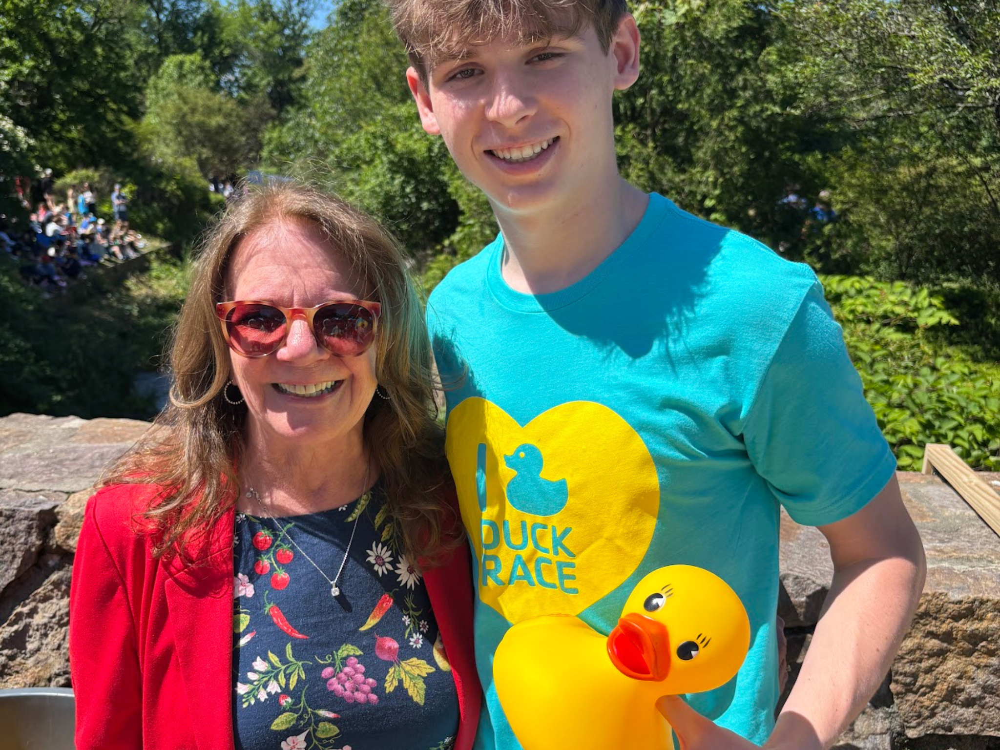 A grown up and teen holding a large rubber duck at the South Mountain YMCA Duck Race