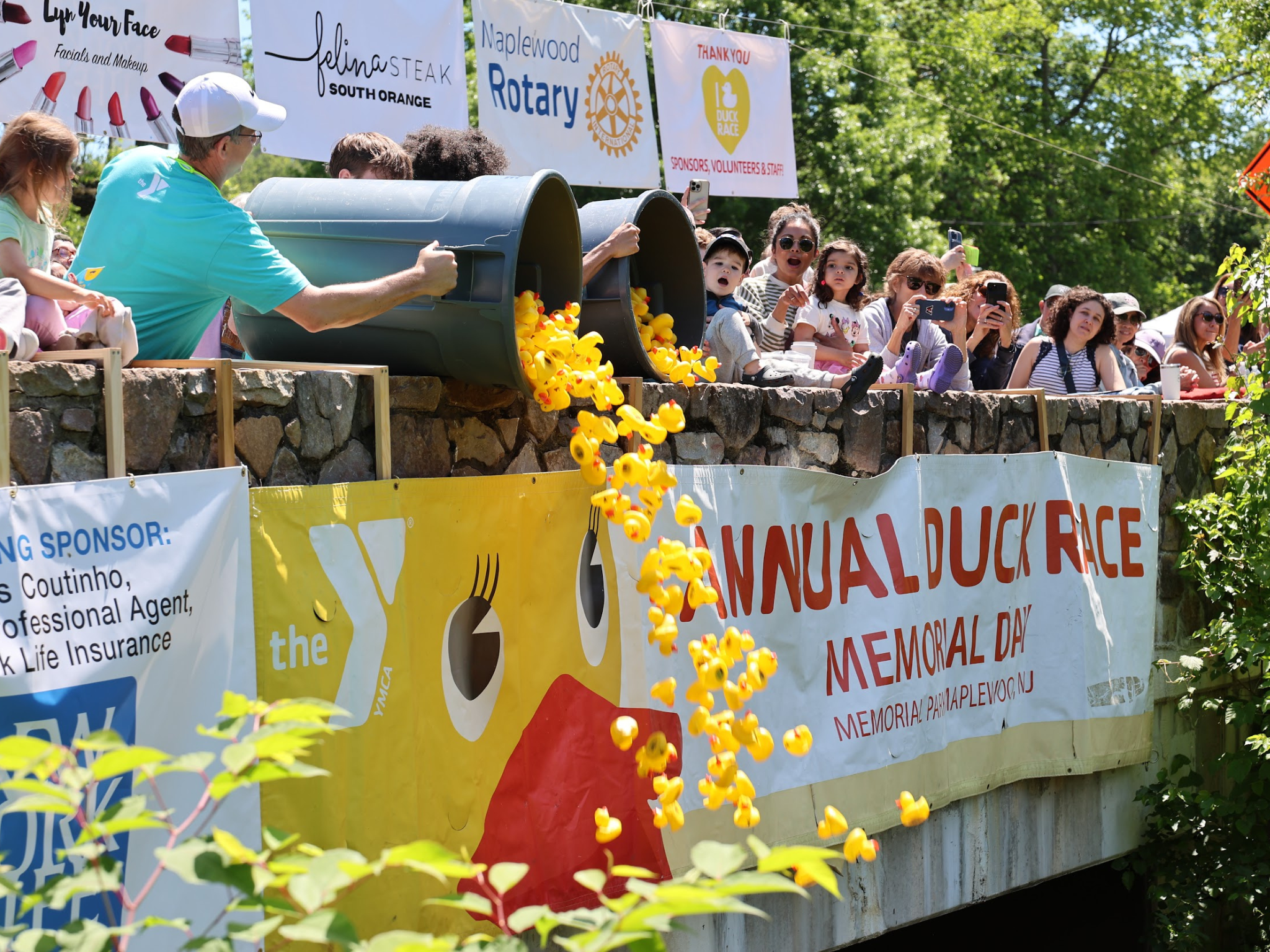 Staff dumping all the rubber ducks in the water at the South Mountain YMCA Duck Race