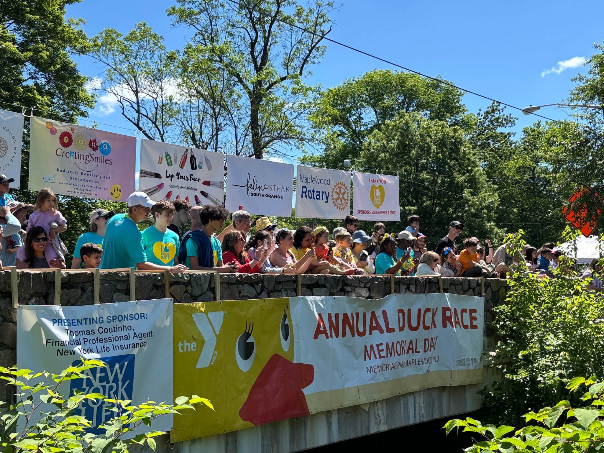 Annual Duck Race banner with a crowd