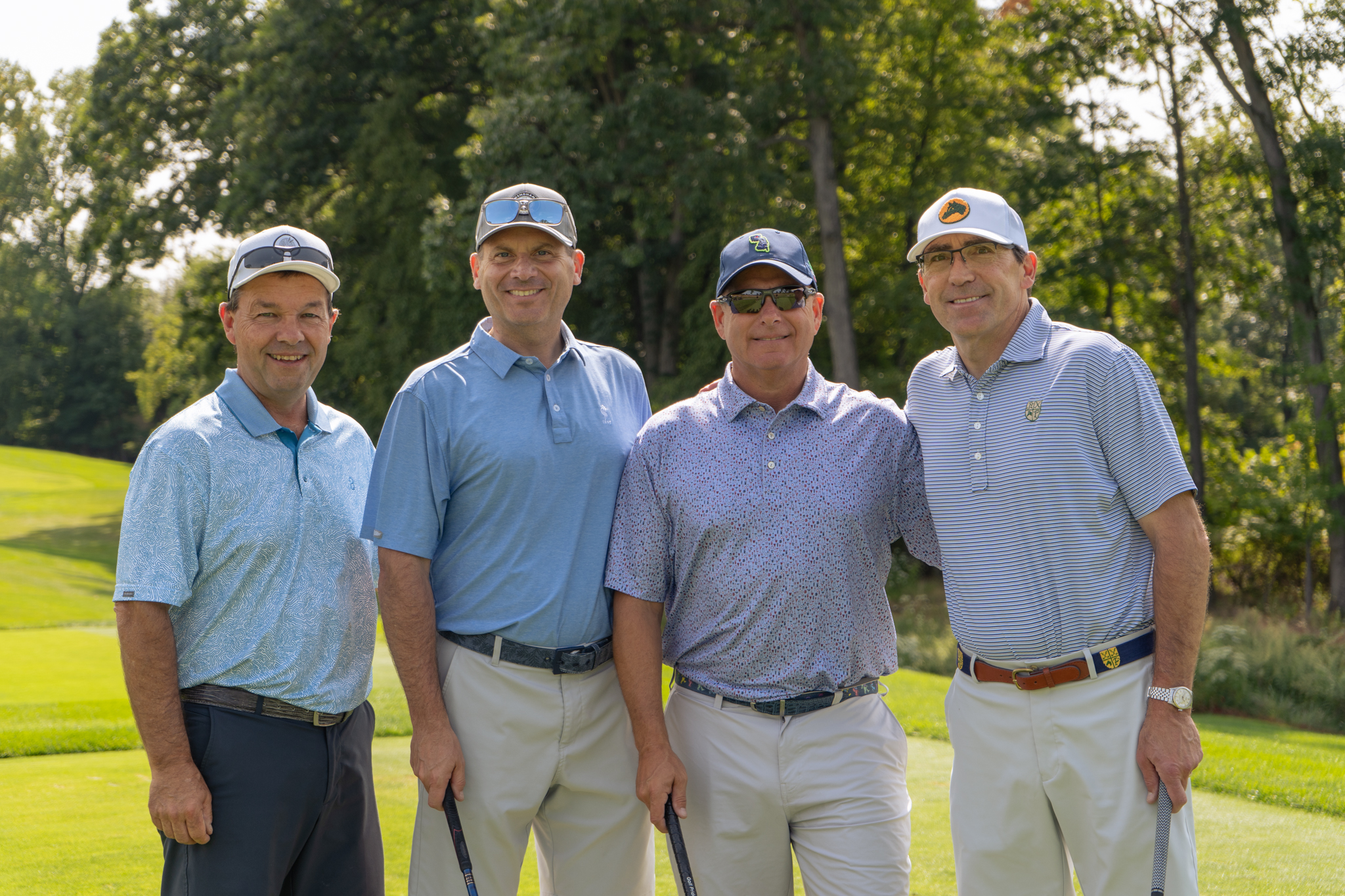 A foursome stop to take a group photo at the Sussex County YMCA Golf Outing