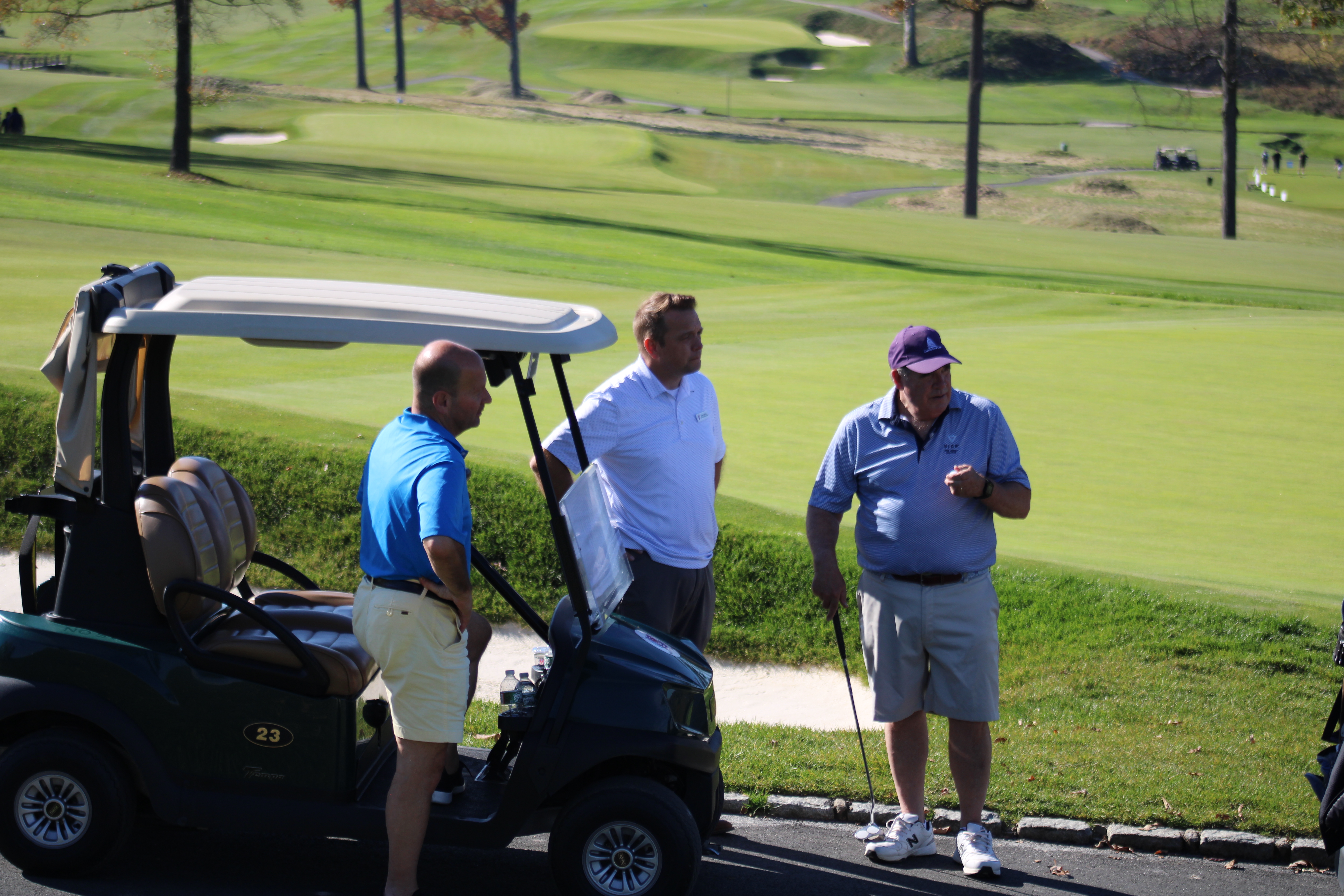 Golf team strategizing at the Metro YMCA Golf Outing in New Jersey