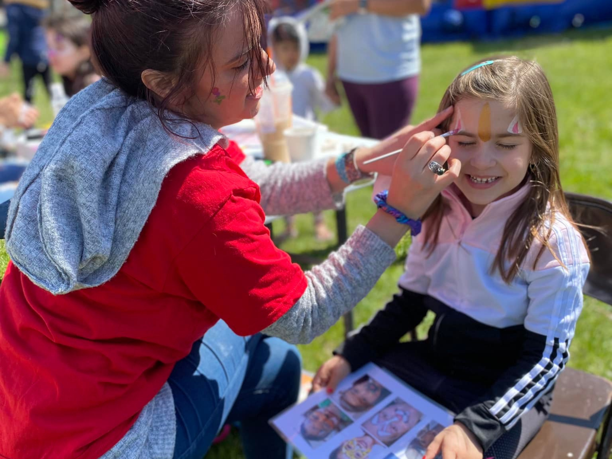 A young girl getting her face painted at Healthy Kids Day