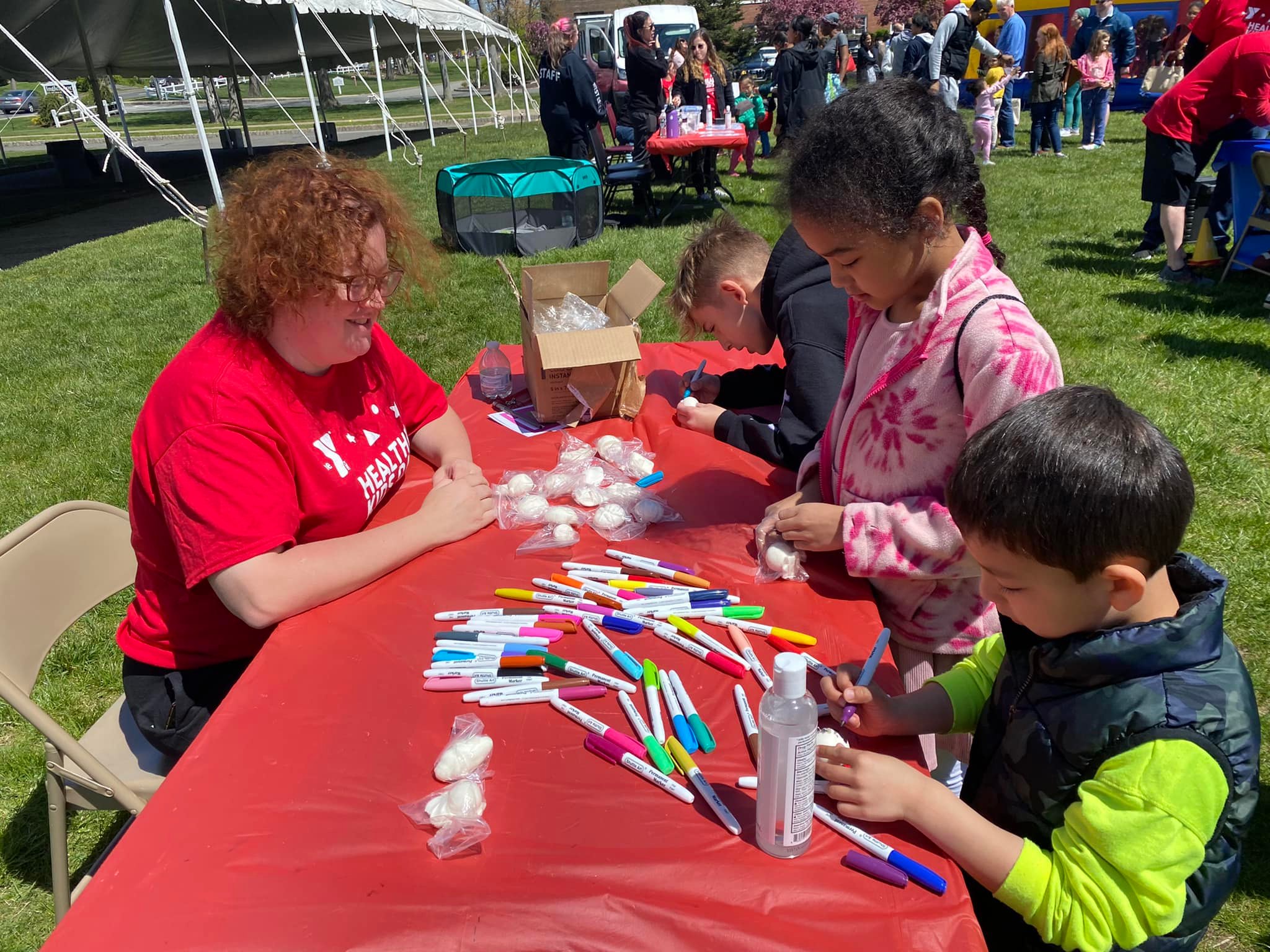 YMCA staff member doing crafts with Healthy Kids Day crafts