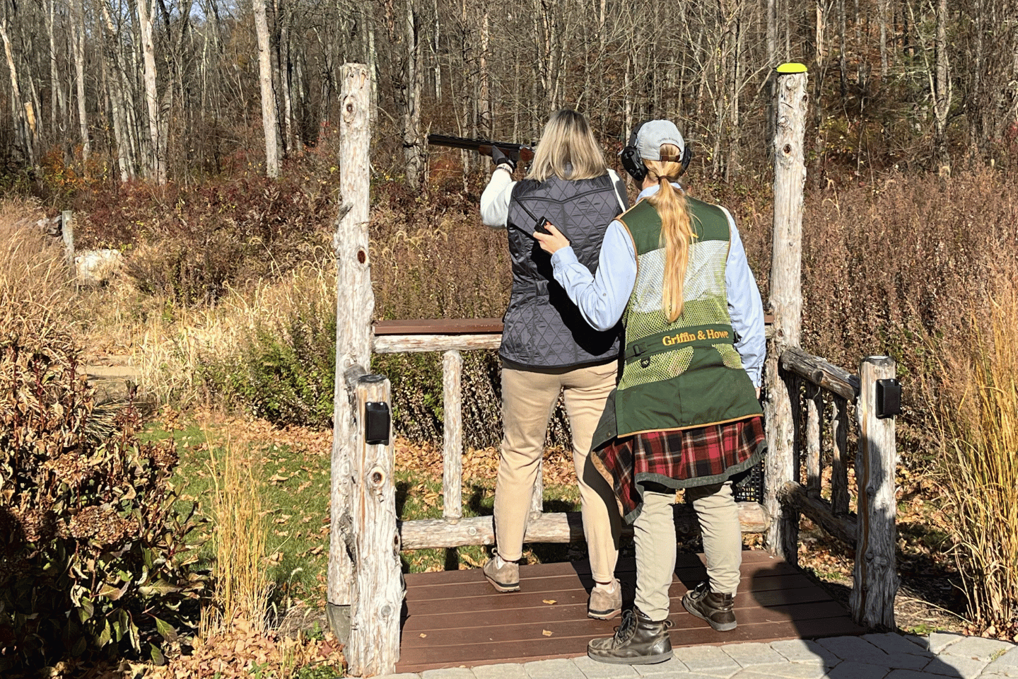 Two women shooting a rifle at the Metro YMCA of the Oranges sporting clays event